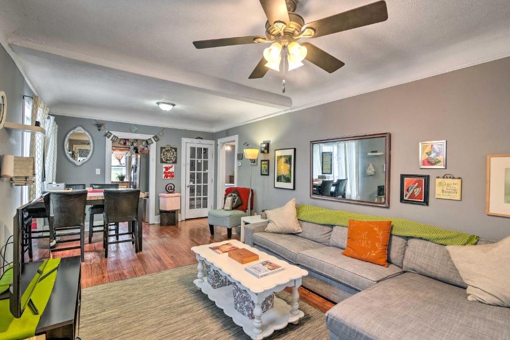 a living room with a couch and a ceiling fan at Eclectic Escape with Sunroom - 2 Miles to Downtown! in Dearborn