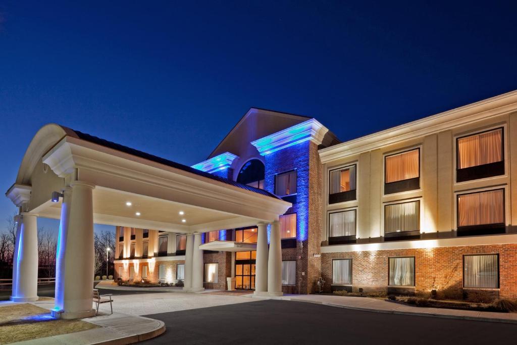 a rendering of a hotel at night at Holiday Inn Express Hotel & Suites Clifton Park, an IHG Hotel in Clifton Park
