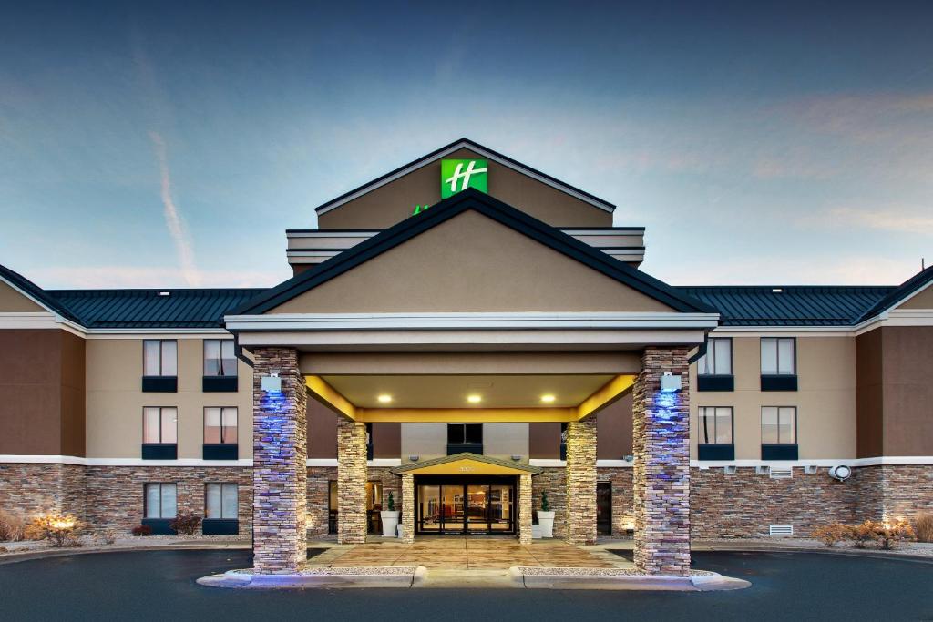 a hotel building with a cross on top of it at Holiday Inn Express Hotel & Suites Cedar Rapids I-380 at 33rd Avenue by IHG in Cedar Rapids