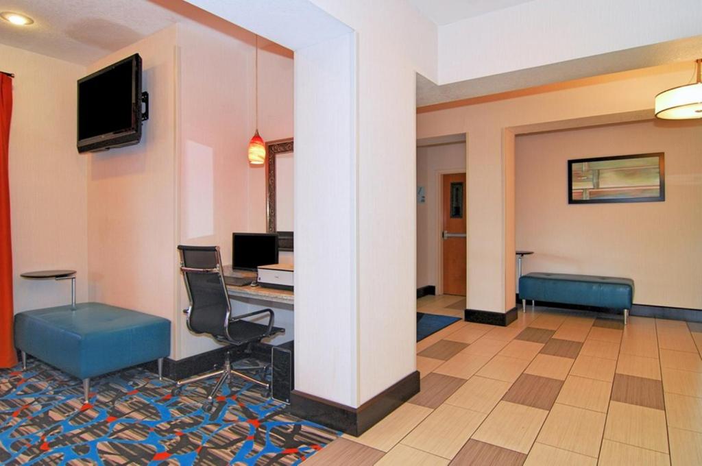 a hotel lobby with a desk and a tv at Holiday Inn Express Destin E - Commons Mall Area, an IHG Hotel in Destin