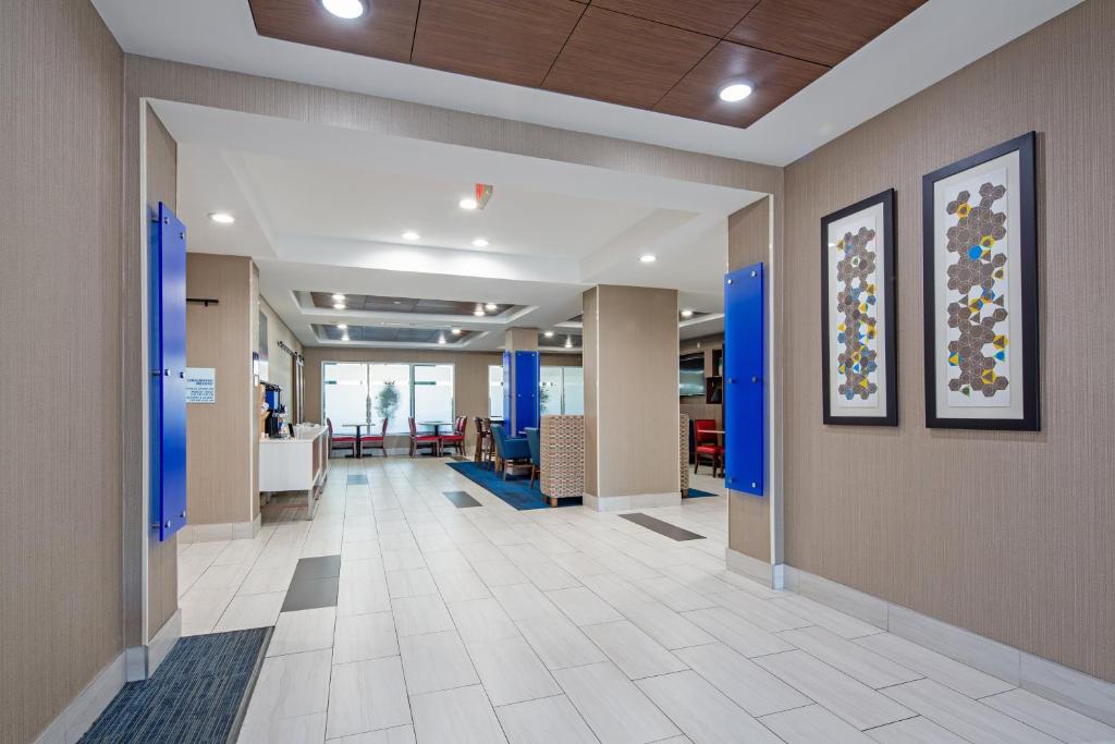 a hallway of an office with blue walls and tile floors at Holiday Inn Express & Suites Chattanooga - East Ridge by IHG in Chattanooga