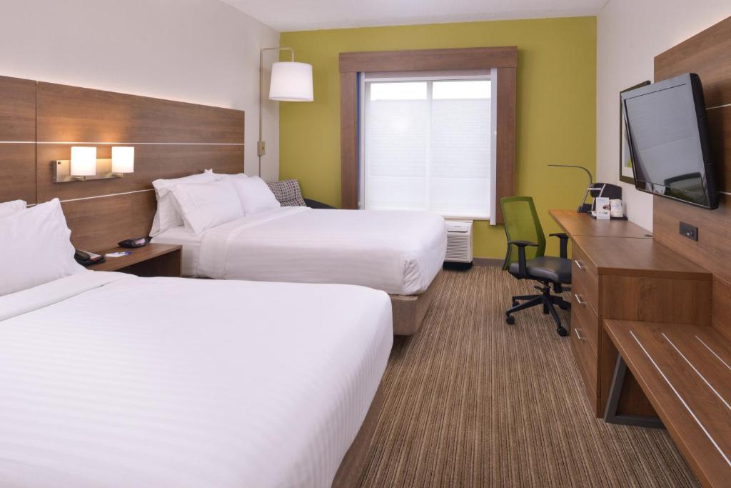 a hotel room with two beds and a flat screen tv at Holiday Inn Express & Suites Chattanooga - East Ridge by IHG in Chattanooga