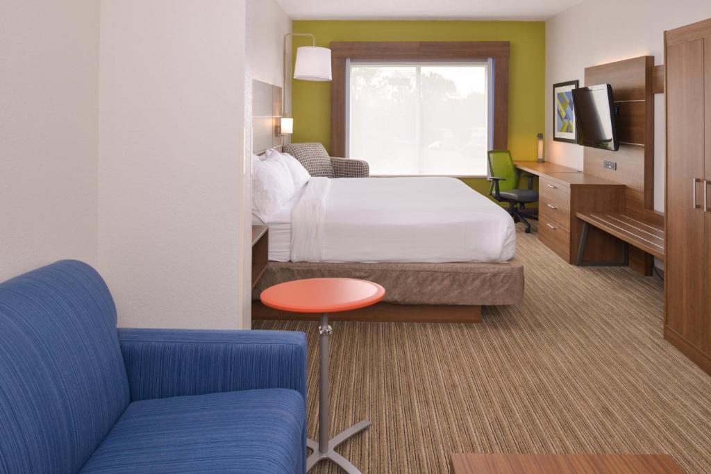 a hotel room with a bed and a couch at Holiday Inn Express & Suites Chattanooga - East Ridge by IHG in Chattanooga