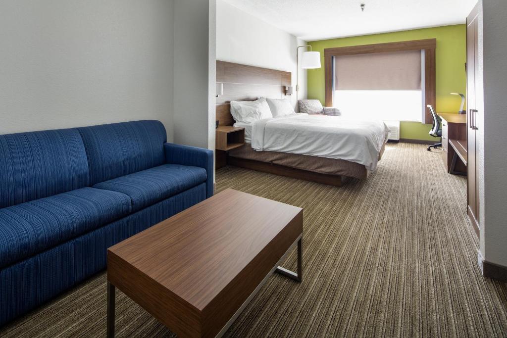 a hotel room with a couch and a bed at Holiday Inn Express & Suites Chattanooga - East Ridge by IHG in Chattanooga