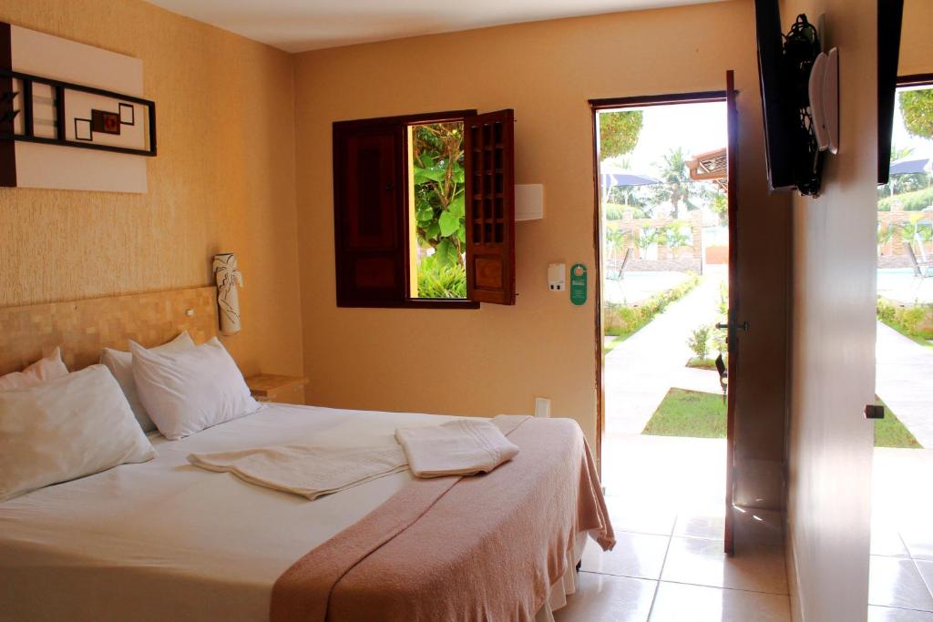 Uma cama ou camas num quarto em Pousada Badejo