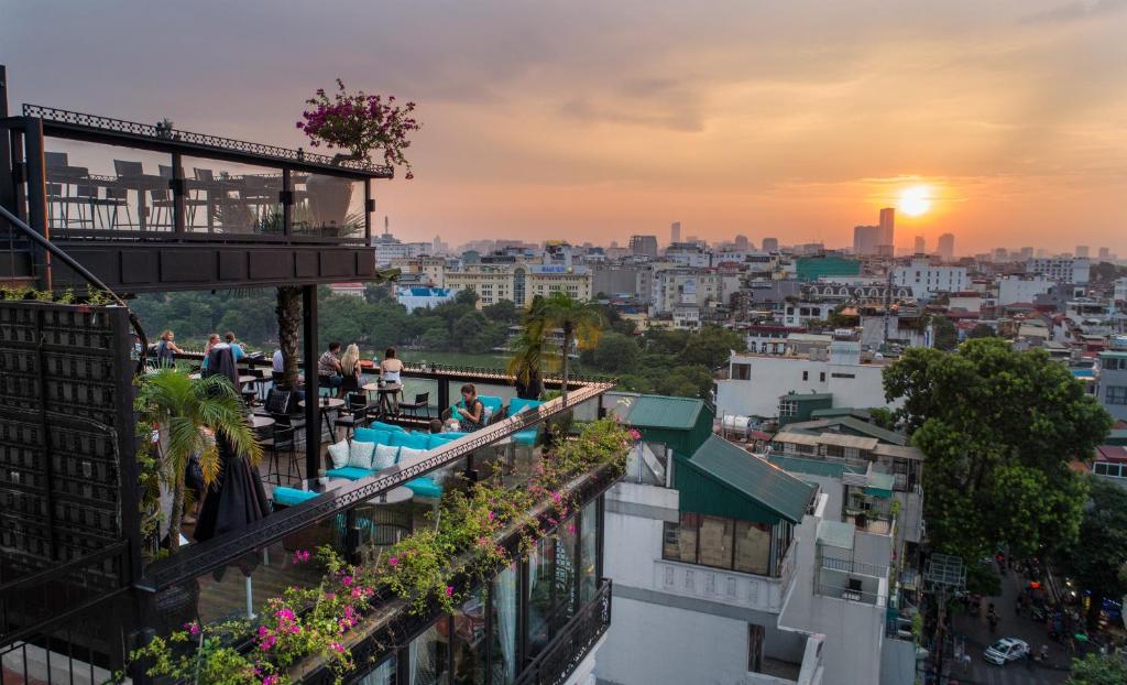 a view of a city at sunset from a building at La Sinfonía Majesty Hotel and Spa in Hanoi