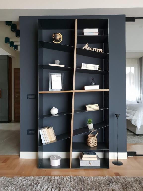 a black book shelf in a living room at Top View Apartaments in Braşov