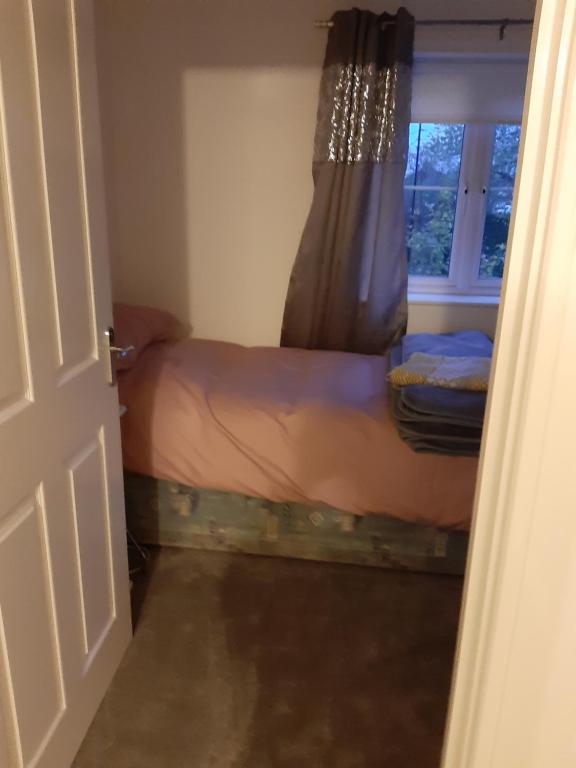 a small bedroom with a bed and a window at Marias House in Newcastle upon Tyne