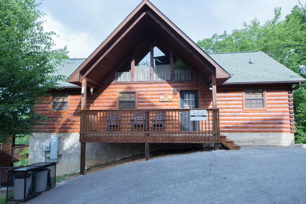 a log cabin with a large deck on the front at Drift Away Cabin in Sevierville