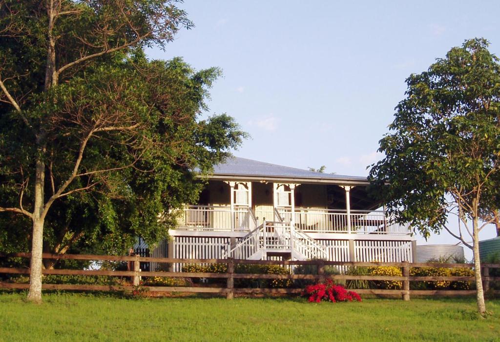 a house with a white porch and a fence at Dayboro - Blue Ridge Lavender Cottage in Dayboro