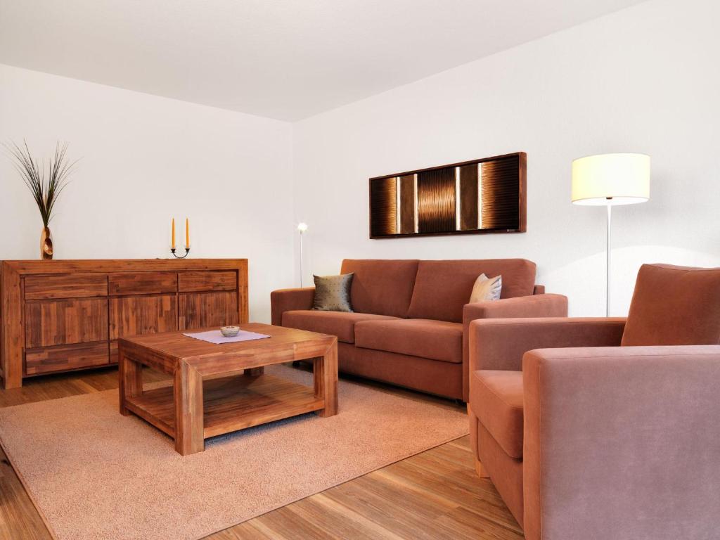 a living room with two couches and a coffee table at Haus Südwester Strandschnecke in Timmendorf