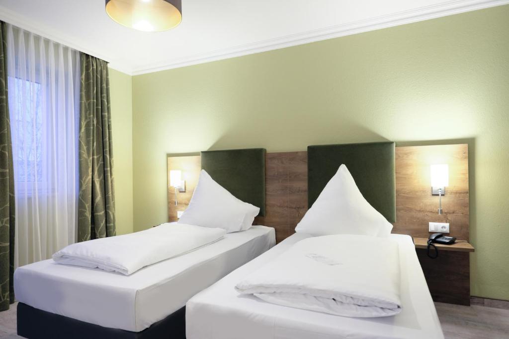Postel nebo postele na pokoji v ubytování Hotel Römerstadt