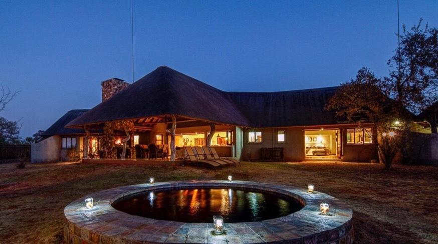 a house with a pool in the yard at Zebula 116 in Mabula