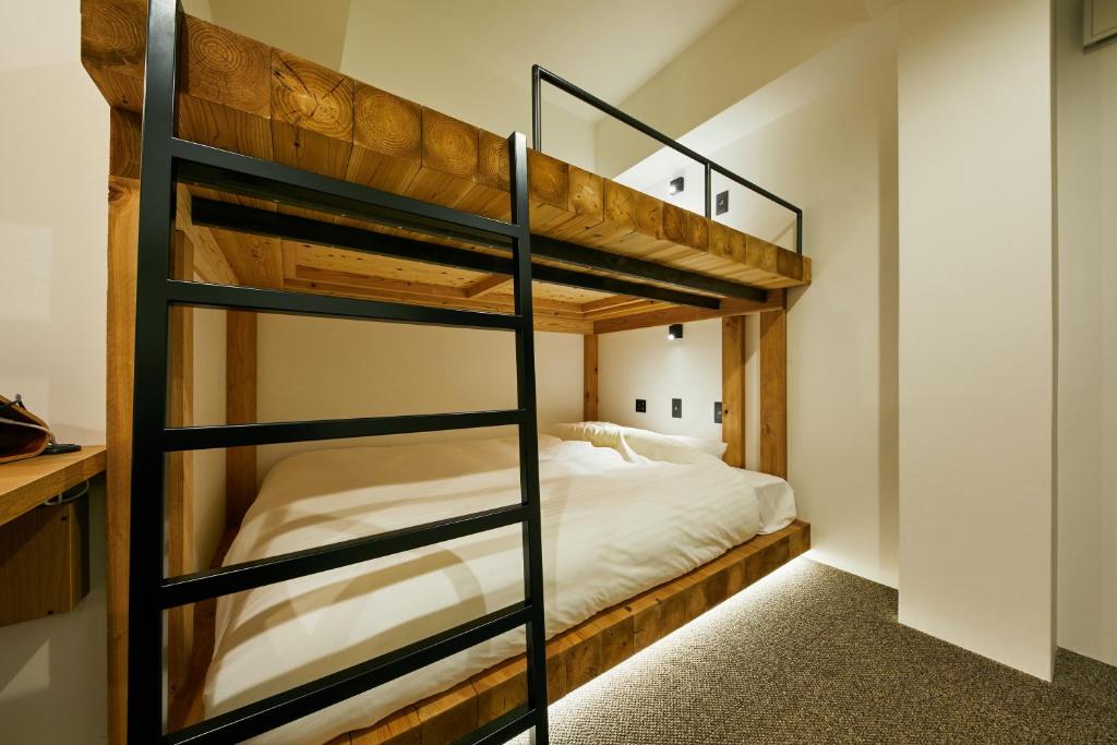 Postel nebo postele na pokoji v ubytování mizuka Daimyo 7 - unmanned hotel -