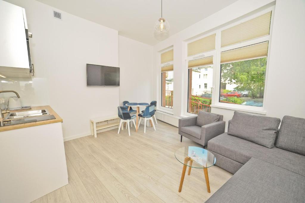 a living room with a couch and a table at Aparment near Monte Cassino by Grand Apartments in Sopot