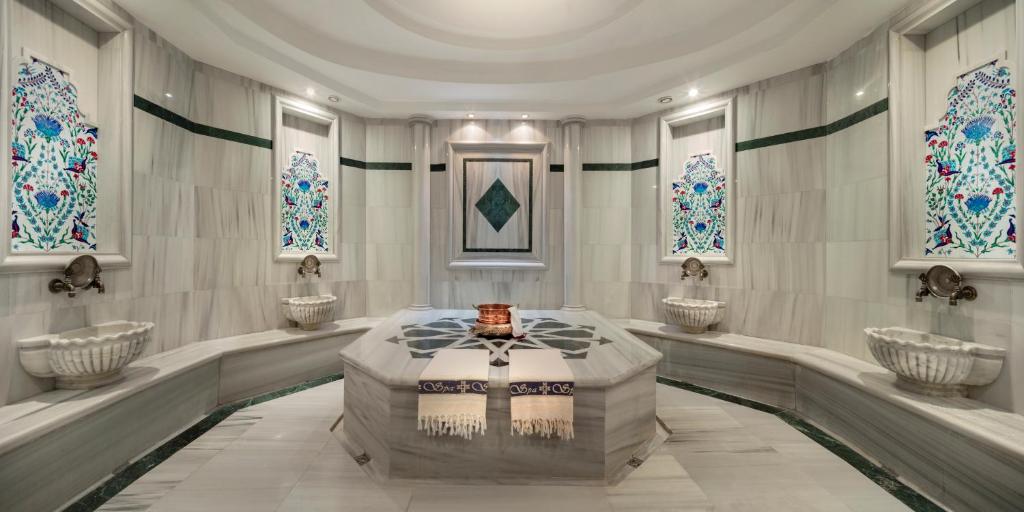 a bathroom with four sinks in a room with windows at Merit Lefkosa Hotel & Casino in North Nicosia