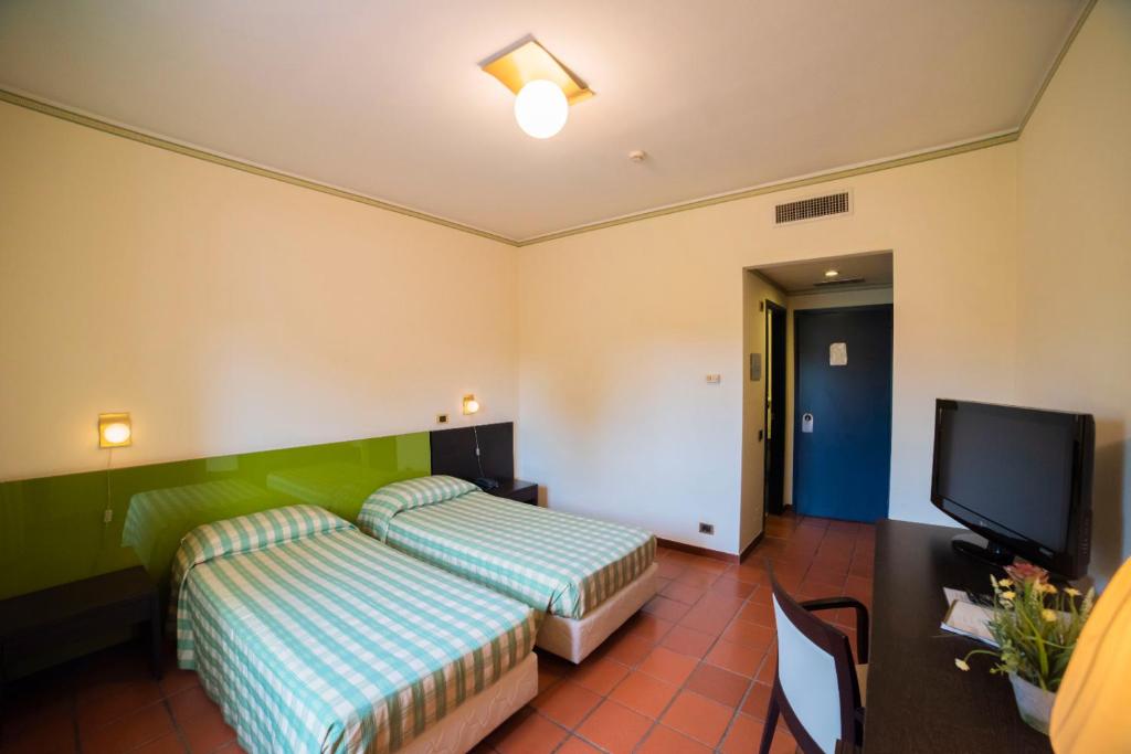 Łóżko lub łóżka w pokoju w obiekcie Orizzonte Acireale Hotel