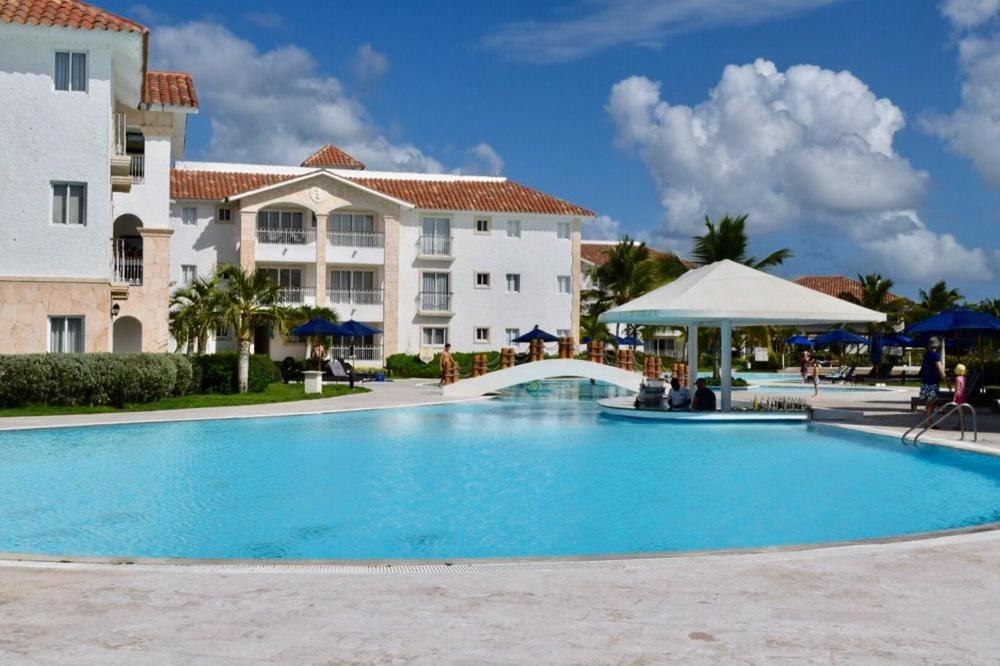 a large swimming pool in front of a building at The blue lagoon of the Caribbean Sea. Velero 205.Cadaques Caribe in La Fragata