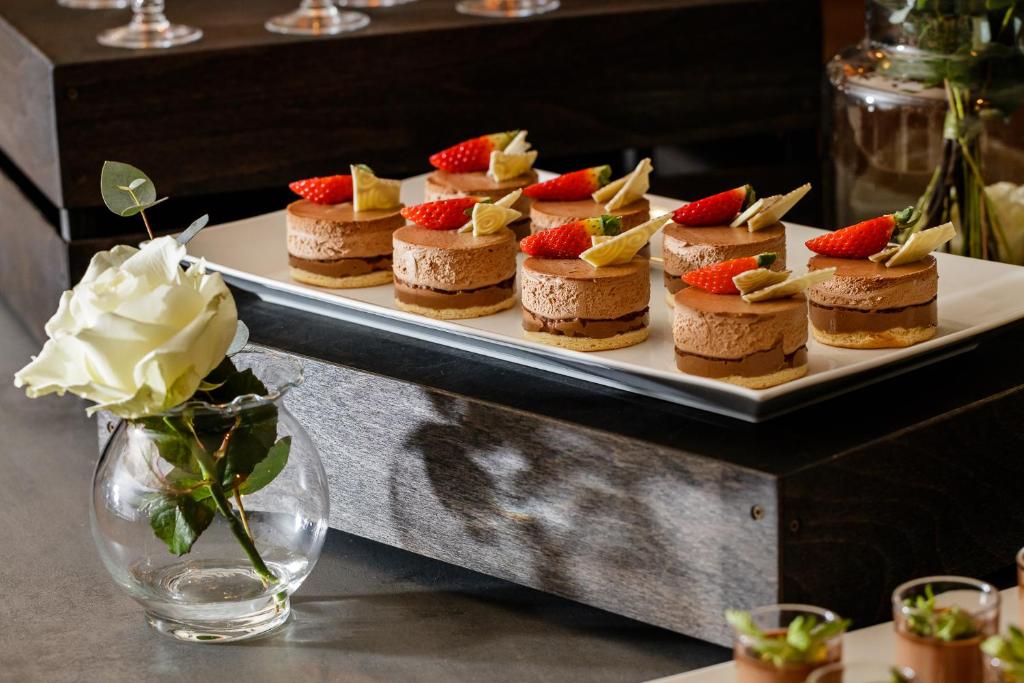 a plate of cakes with strawberries on top of it at Spa Hotel Felicitas in Poděbrady