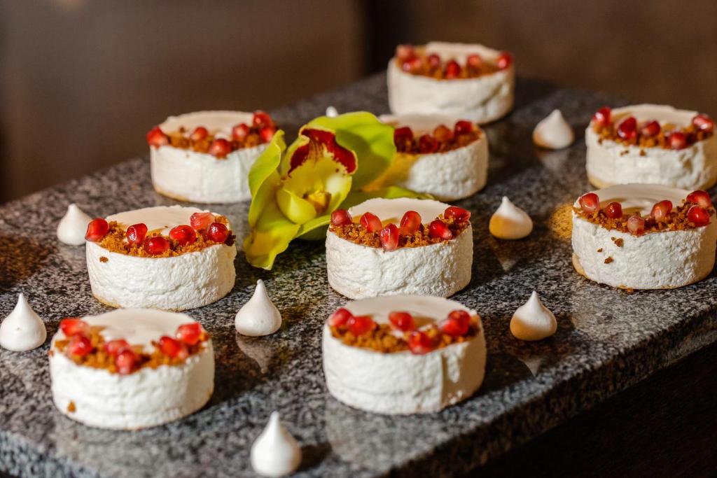 a group of cakes on a table with toppings at Spa Hotel Felicitas in Poděbrady
