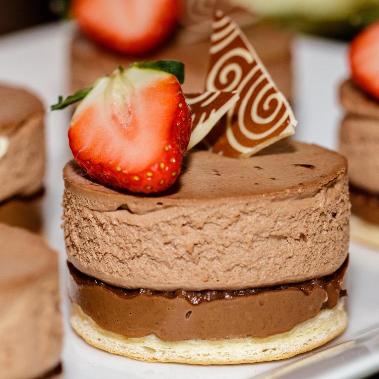 a chocolate cake with a strawberry on top on a plate at Spa Hotel Felicitas in Poděbrady