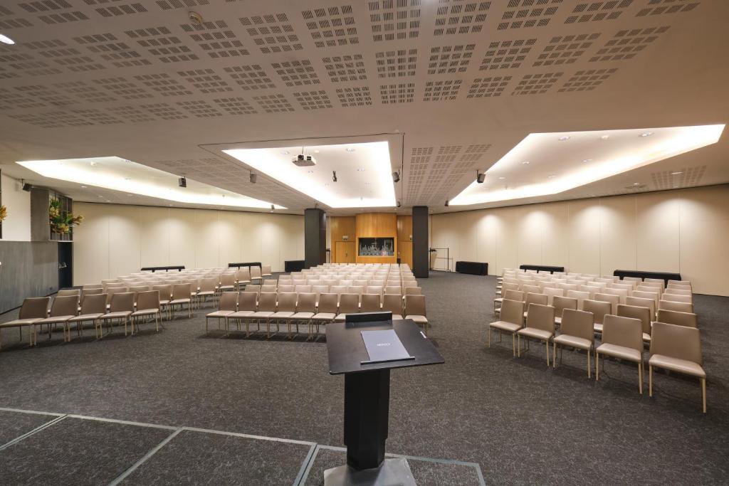 an empty room with chairs and a podium in the middle at Hotel SB Icaria in Barcelona