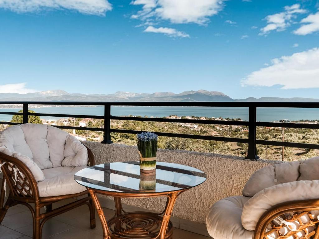 a balcony with a table and chairs and a view of the desert at Holiday villa with sea view in Paralia Avlidas in Dhílesi
