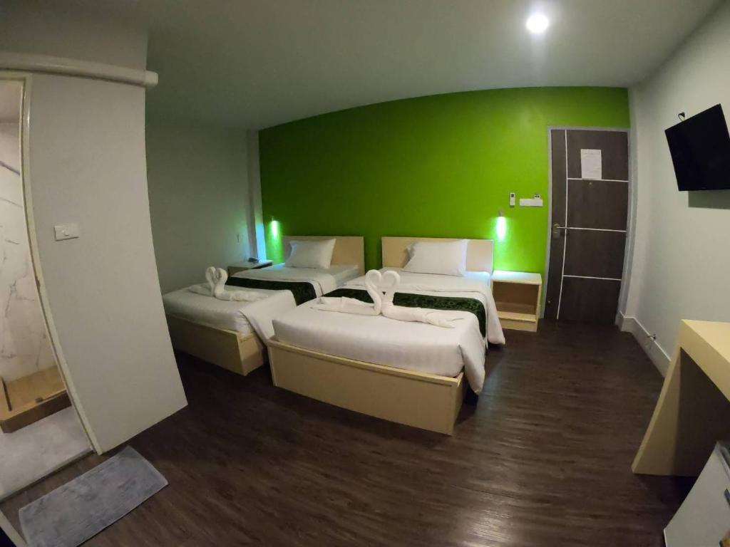 Postel nebo postele na pokoji v ubytování Thap Sakae Hotel