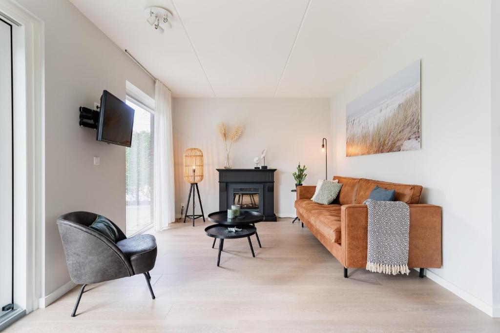 a living room with a couch and a fireplace at Vakantiewoning Seaside in Oostkapelle