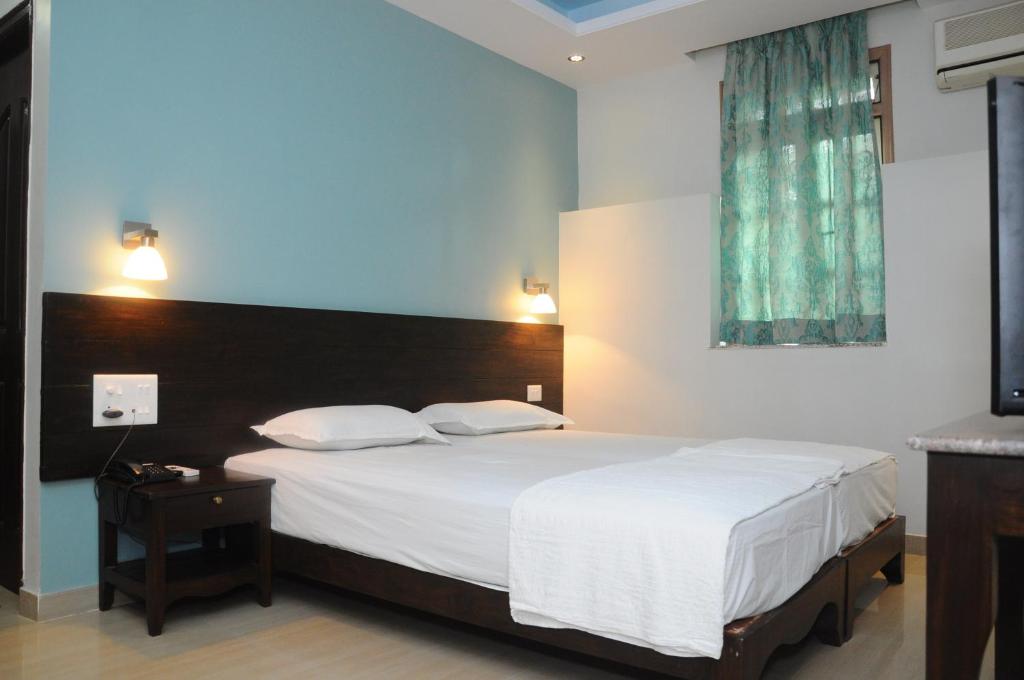 Postel nebo postele na pokoji v ubytování Palolem Guest House