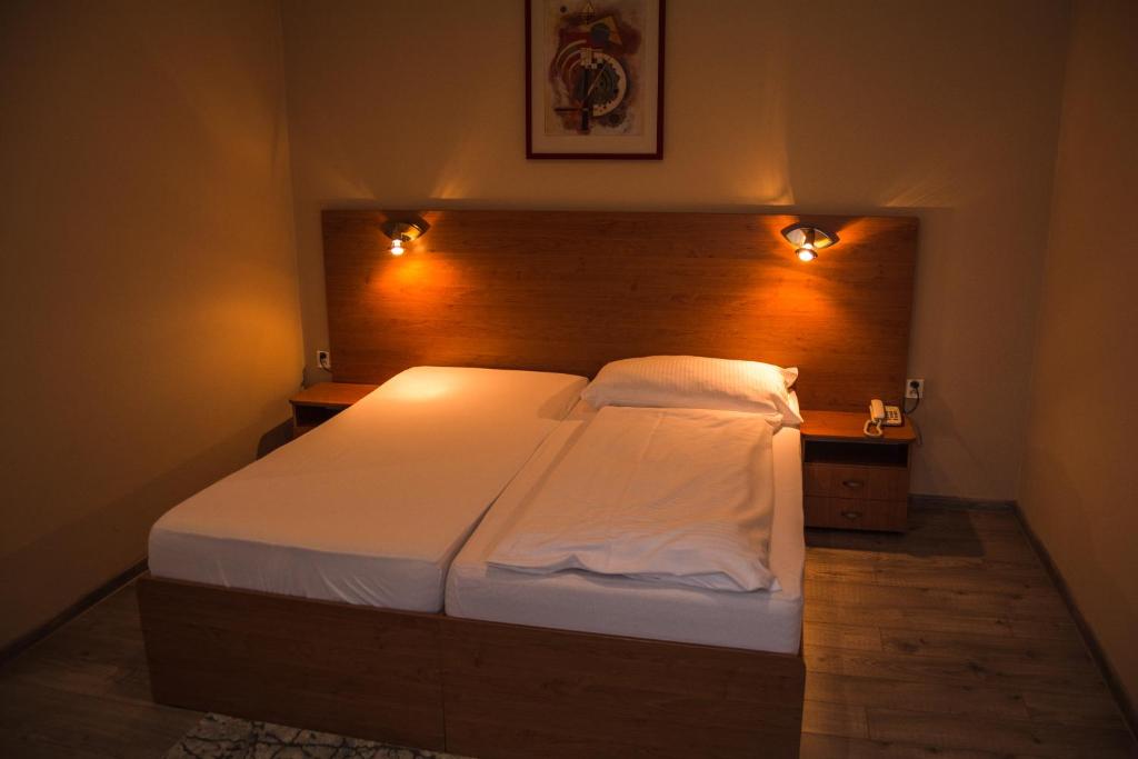 A bed or beds in a room at Hotel Roháč