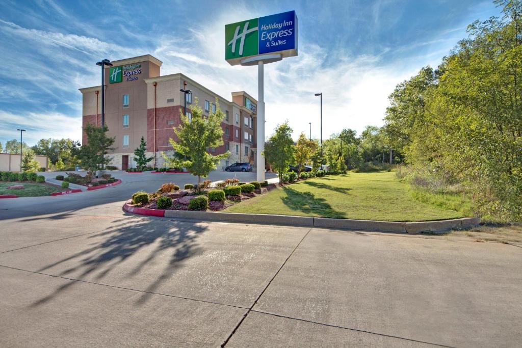 a sign for a hotel on the side of a road at Holiday Inn Express and Suites Oklahoma City North, an IHG Hotel in Oklahoma City