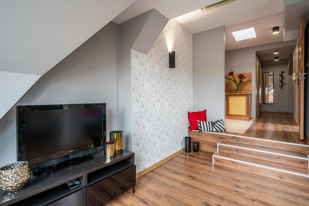 a living room with a large flat screen tv at Absynt Hostel Wrocław in Wrocław