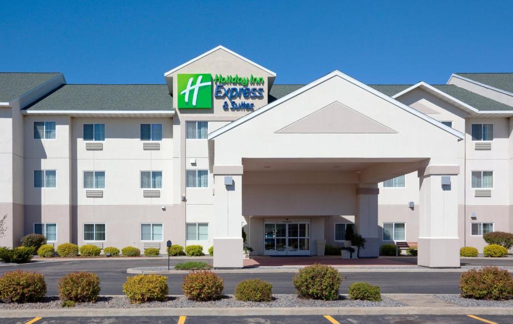 a hotel with a sign on the front of a building at Holiday Inn Express Hotel and Suites Stevens Point, an IHG Hotel in Stevens Point