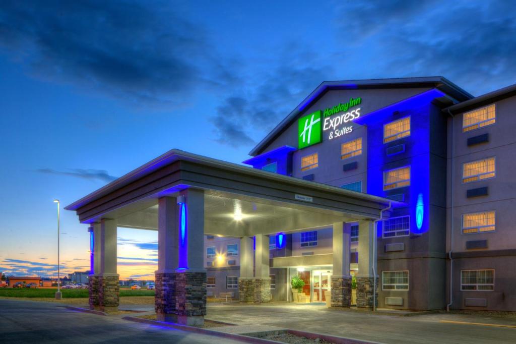 a building with a lit up sign on it at Holiday Inn Express and Suites Dawson Creek, an IHG Hotel in Dawson Creek