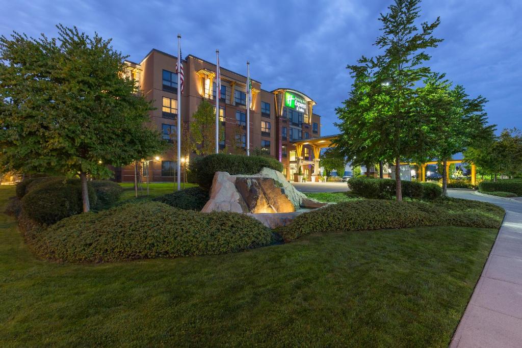 a fountain in a park in front of a building at Holiday Inn Express & Suites Riverport Richmond by IHG in Richmond