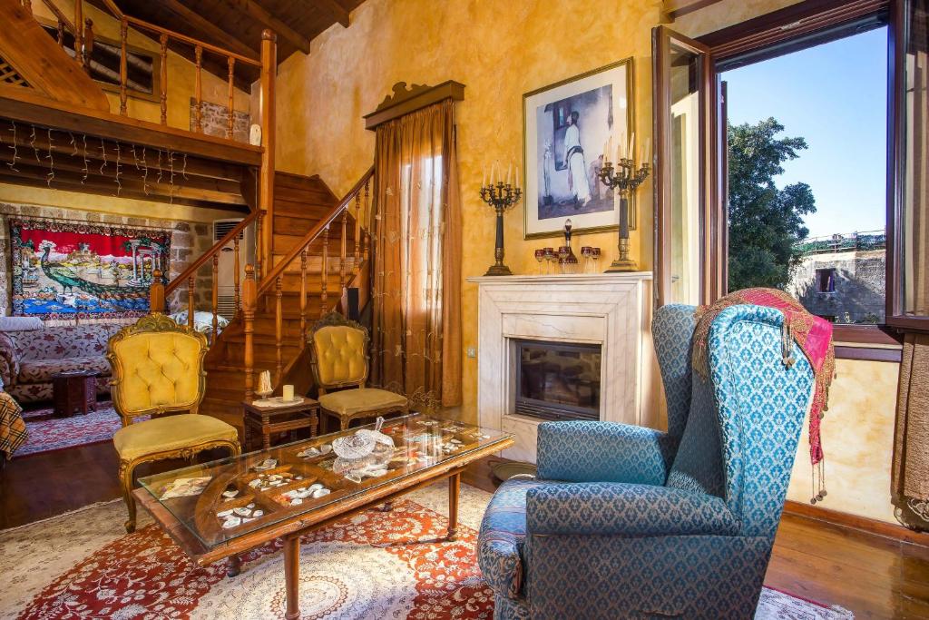 a living room with a table and chairs and a fireplace at CASA DI ALEJANDRO in Rhodes Town