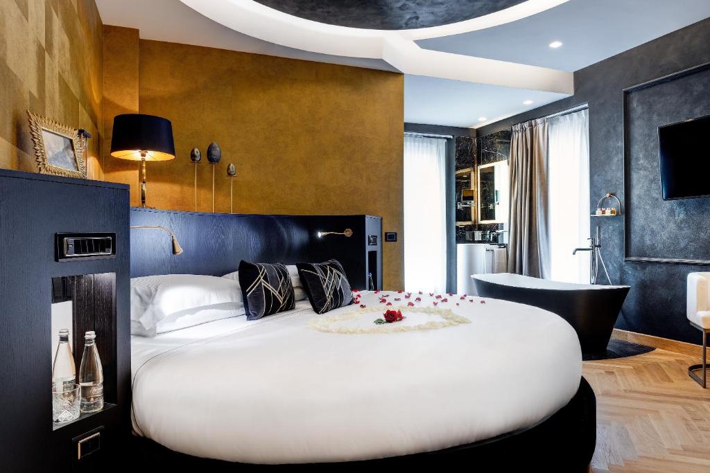 
a hotel room with a bed and a tv at Dharma Boutique Hotel & SPA in Rome
