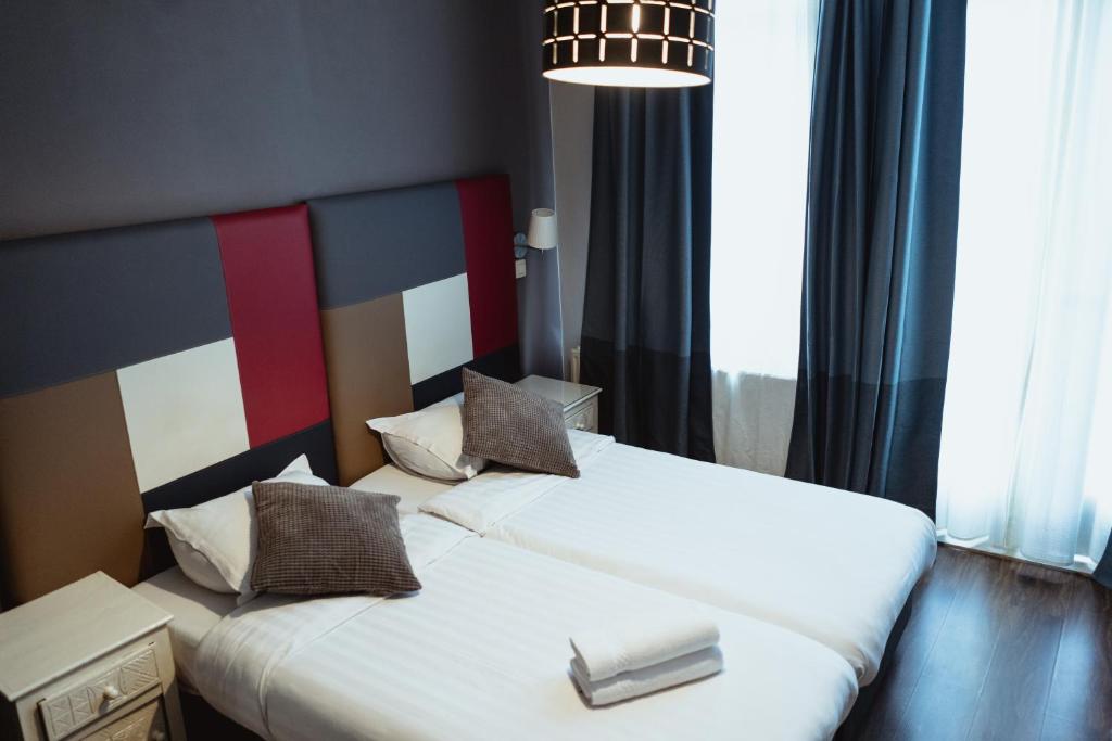 Postel nebo postele na pokoji v ubytování Hotel Le Centenaire Brussels Expo
