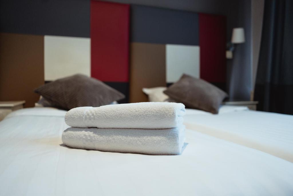 Postel nebo postele na pokoji v ubytování Hotel Le Centenaire Brussels Expo