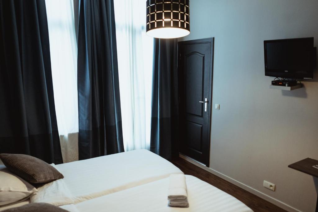 Postel nebo postele na pokoji v ubytování Hotel Le Centenaire Brussels Expo
