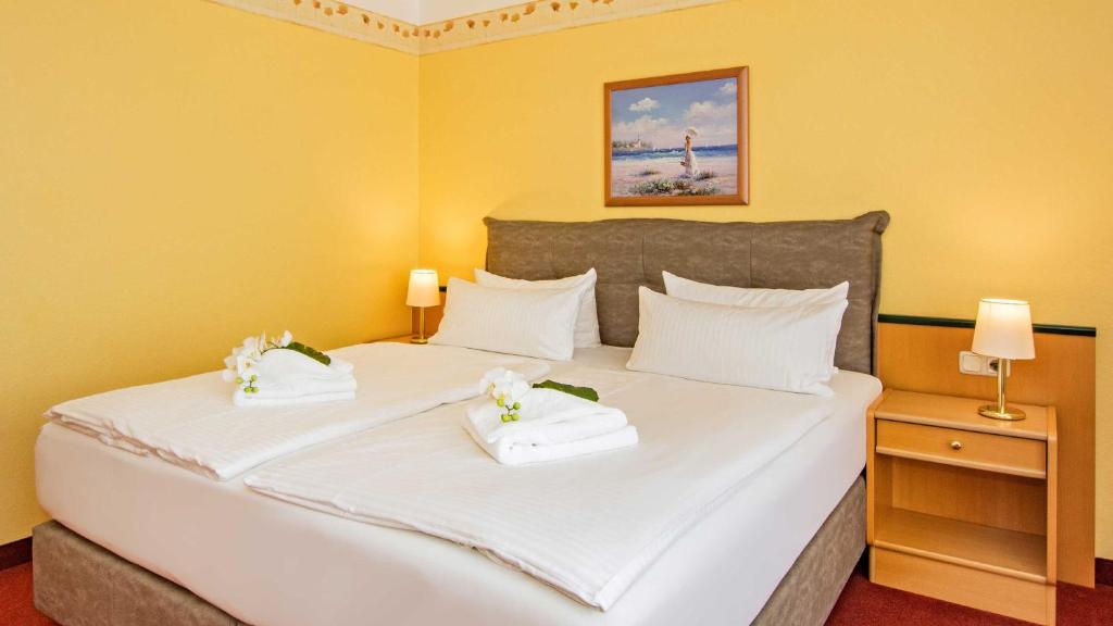 Postel nebo postele na pokoji v ubytování Hotel Garni Nussbaumhof