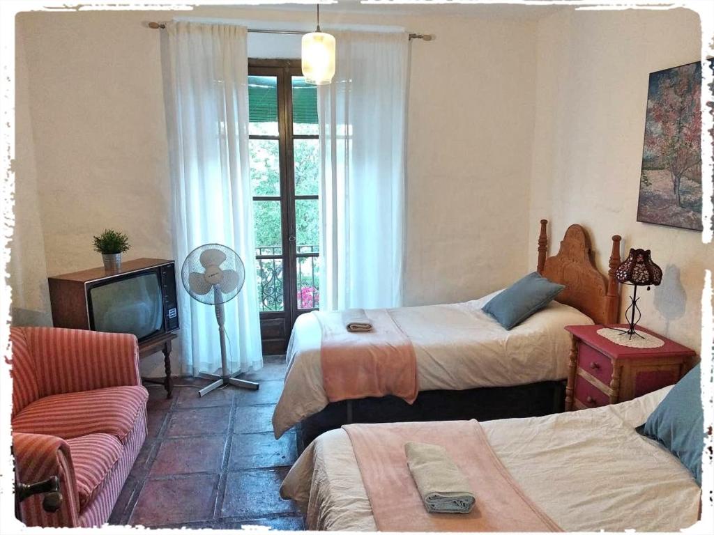 Posteľ alebo postele v izbe v ubytovaní Cortijo Casas Viejas
