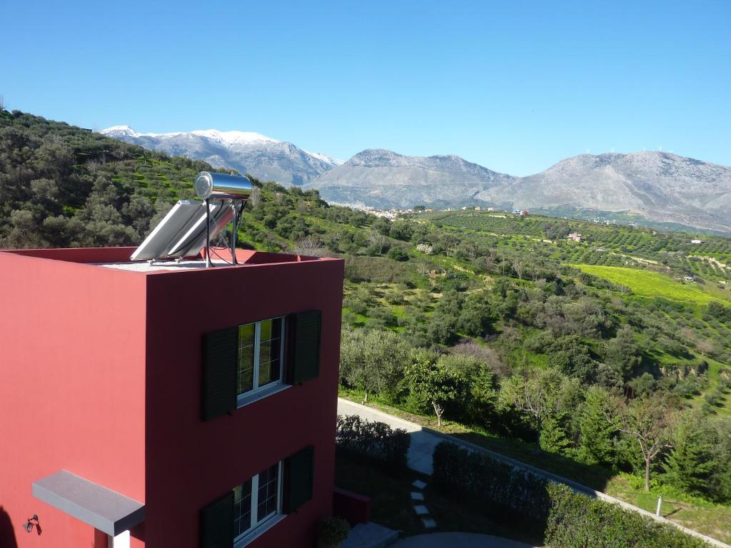 a building with a view of a valley and mountains at Entire independent maisonette near Heraklion Pottery Classes in Petrokefalo