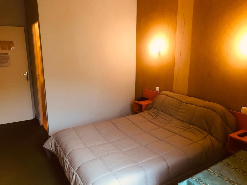 Letto o letti in una camera di Hotel Restaurant L'AGAPANTHE