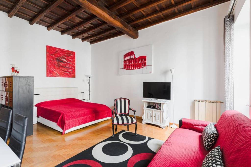 - un salon avec un lit rouge et un canapé rouge dans l'établissement World Wide Bed Piazza del Popolo, à Rome