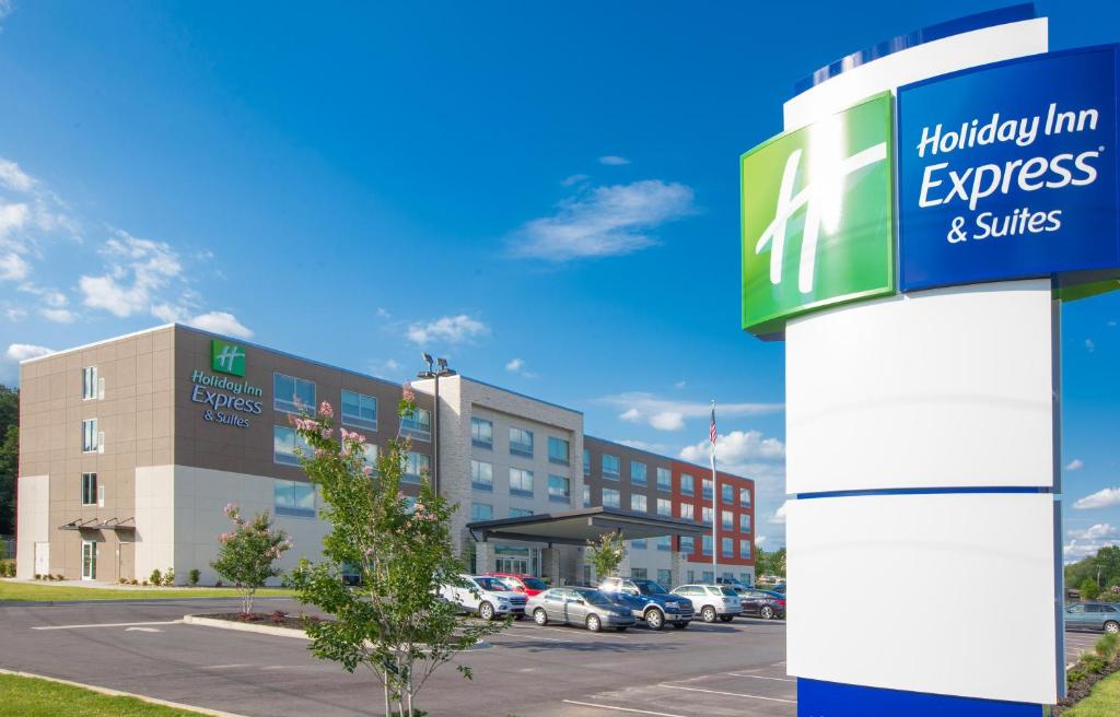 a sign in front of a building with a parking lot at Holiday Inn Express & Suites Greenwood Mall, an IHG Hotel in Greenwood