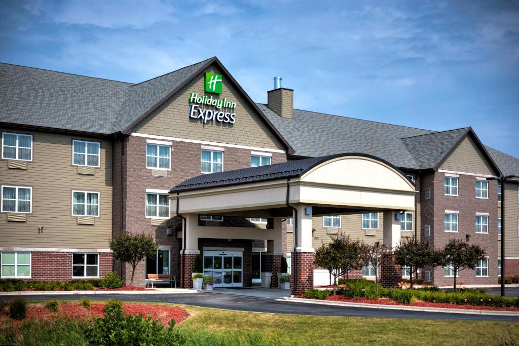 a hotel building with a hilton express sign on it at Holiday Inn Express & Suites - Green Bay East, an IHG Hotel in Green Bay