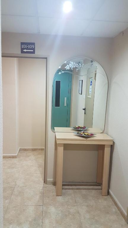 a dressing room with a mirror on a table at Hostal El Altet in El Alted