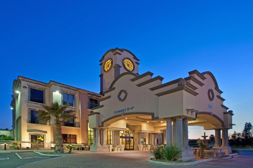 a building with a clock on the front of it at Holiday Inn Express Hotel & Suites Tucson Mall by IHG in Tucson